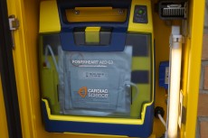 Photograph of open community access box revealing defibrillator inside
