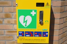 Photograph of a Community Access Defibrillator attached to wall