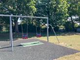 Two Cradle swings in front of the Oak tree hedge line